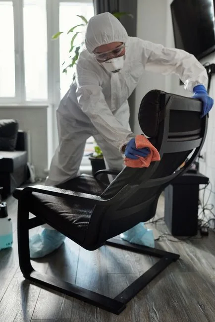 A man in a harness cleaning skyscraper windows with precision.